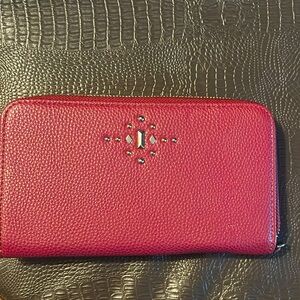 Maroon leather clutch purse.